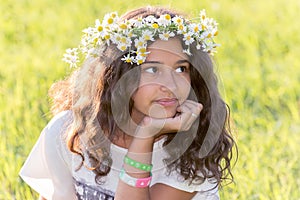 teenage girl with wreath from field Camomile on her head