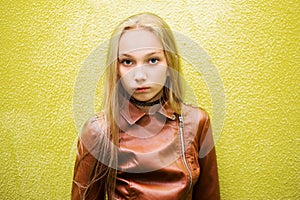 Teenage girl on a yellow wall background