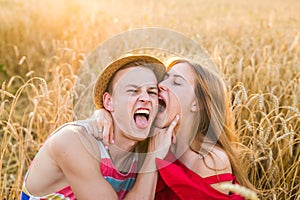 Teenage girlfriend and boyfriend having fun outdoors, kissing, hugging, love concept.