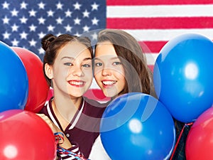 Teenage girls with balloons over american flag