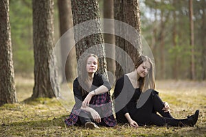 Teenage girls best friends sitting in the forest. Nature.