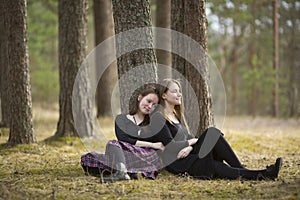 Teenage girls best friends sitting in the forest. Nature.