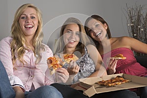 Teenage Girls Eating Pizza