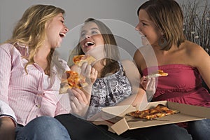 Teenage Girls Eating Pizza