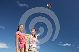 Teenage girls flying a kite