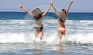 Teenage Girls Going into the Ocean at the Beach