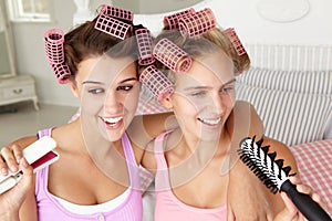 Teenage girls with hair in curlers