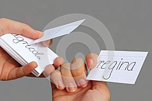 teenage girls, holding file cards with latin vocabulary, learning for school