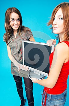 Teenage Girls Holding Monitor