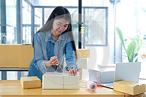 Teenage girls are packing the products in the box and using a rope to deliver to customers