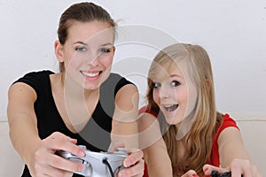 Teenage girls playing playstation photo