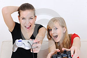 Teenage girls playing playstation photo