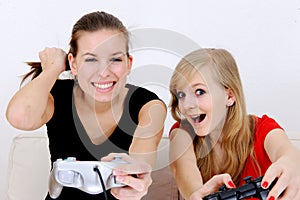 Teenage girls playing playstation photo