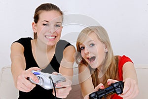 Teenage girls playing playstation photo