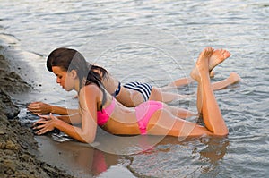 Teenage girls playing in the sand