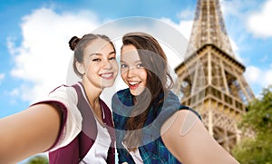 Teenage girls taking selfie over eiffel tower