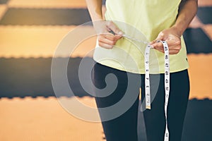 Teenage girls use their own waist measurement straps. To control