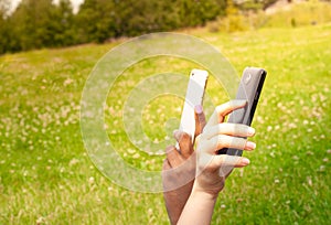 Teenage girls using mobile smart phones outdoor