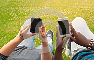 Teenage girls using mobile smart phones outdoor