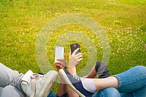 Teenage girls using mobile smart phones outdoor