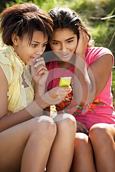 Teenage girls using phone