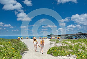 Teenage girls walking on  the beautiful beach on summer vacation.