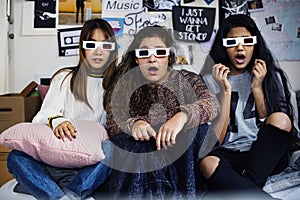 Teenage girls wearing 3d movie eyeglasses