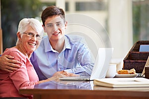 Teenage Grandson Helping Grandmother With Laptop