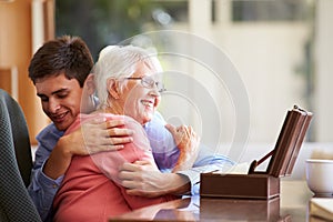 Teenage Grandson Hugging Grandmother