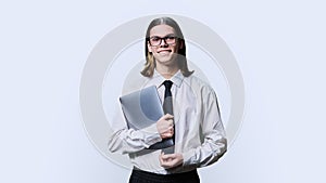 Teenage guy college student posing with laptop in hands on white background