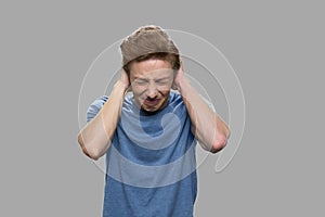 Teenage guy suffering from severe headache.