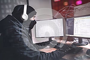 Teenage Hacker man Using her Computer to Organize Malware Attack on Global Scale. She`s in Underground Secret Location Surrounded