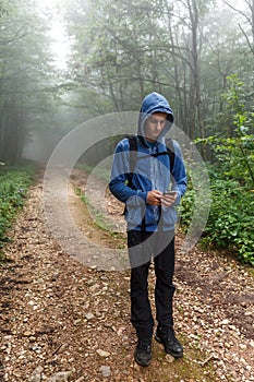 Teenage hiker using gps outdoor