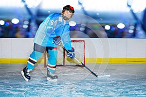 Teenage hockey player during practice at ice arena