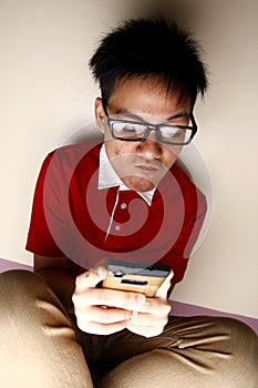 Teenage kid using a smartphone intensely