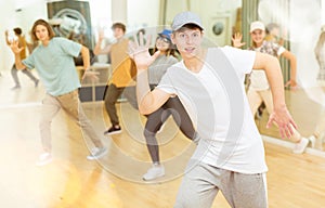 Teenage krump dancer dancing with teenagers in choreographic studio