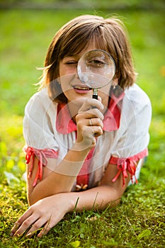 Teenage with magnifying glass