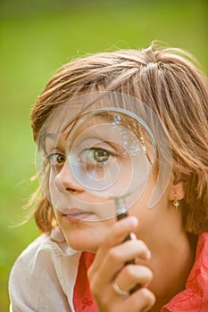 Teenage with magnifying glass