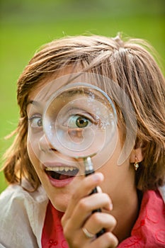 Teenage with magnifying glass