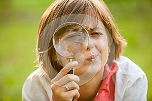 Teenage with magnifying glass