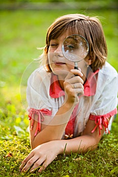 Teenage with magnifying glass