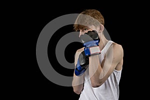 A Teenage Male Boxer and Black Background