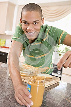 Teenage Male Making Peanut Butter Sandwich