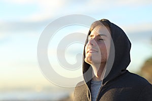Teenage man breathing fresh air on the beach
