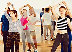 Teenage partners studying dancing of partner dance