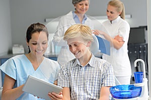 Teenage patient with professional dentist point tablet