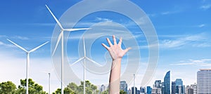 Teenage rise hands up in the Green City. the future concept of renewable energy.