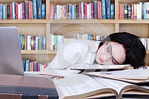 Teenage schoolgirl sleeping in library
