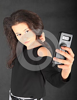 Teenage schoolgirl taking selfie on smartphone