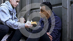 Teenage sharing lunch with afro-american friend, support in hard situation